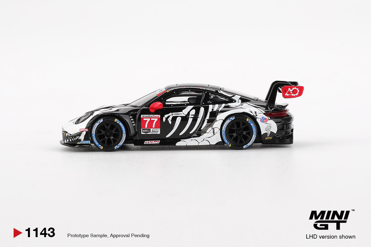 Mini GT 1:64 Porsche 911 GT3 R #77 AO Racing "Skeleton Rexy" IMSA 2025 Petit Le Mans